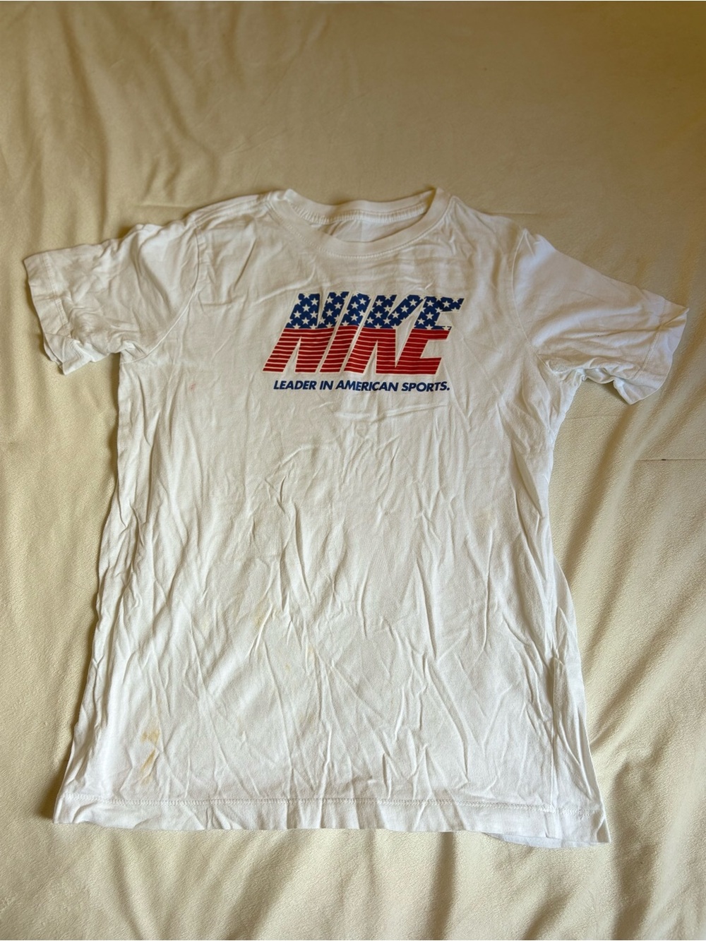 Nike White Kid's Graphic Tee with Red & Blue Flag Logo